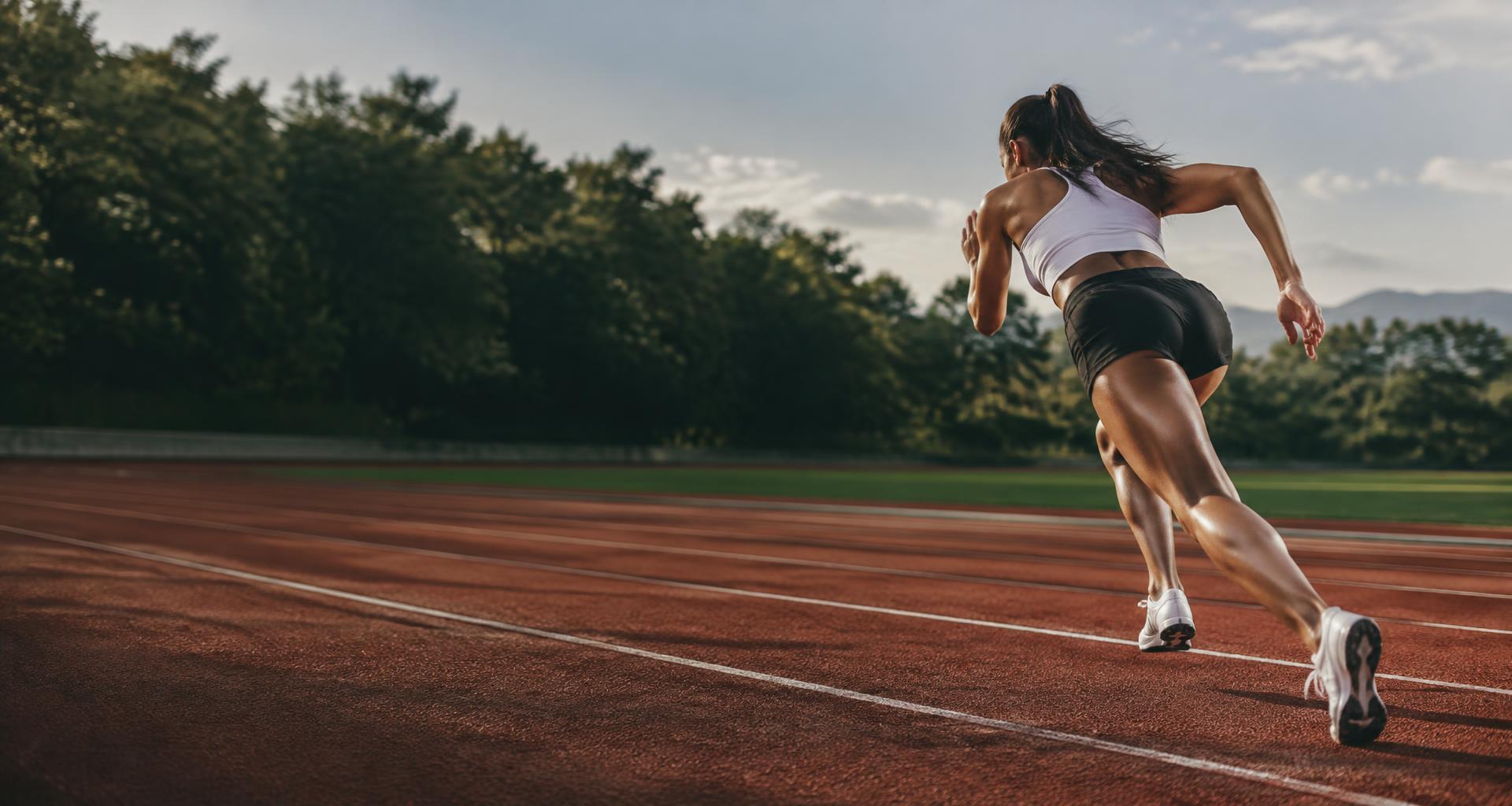 Runner accelerating along the track